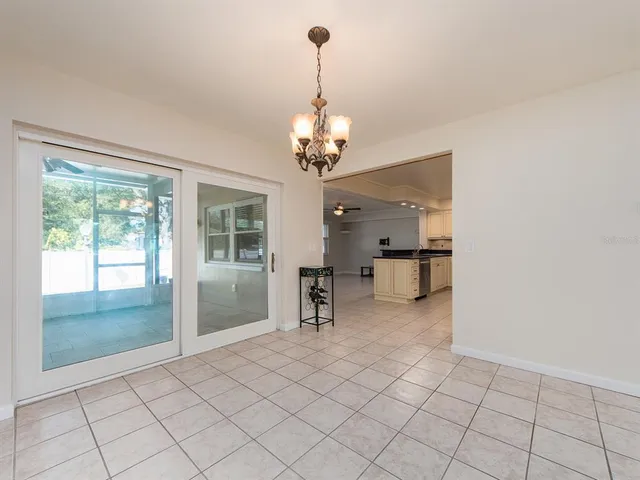 a view of a livingroom with a furniture wooden floor and a chandelier