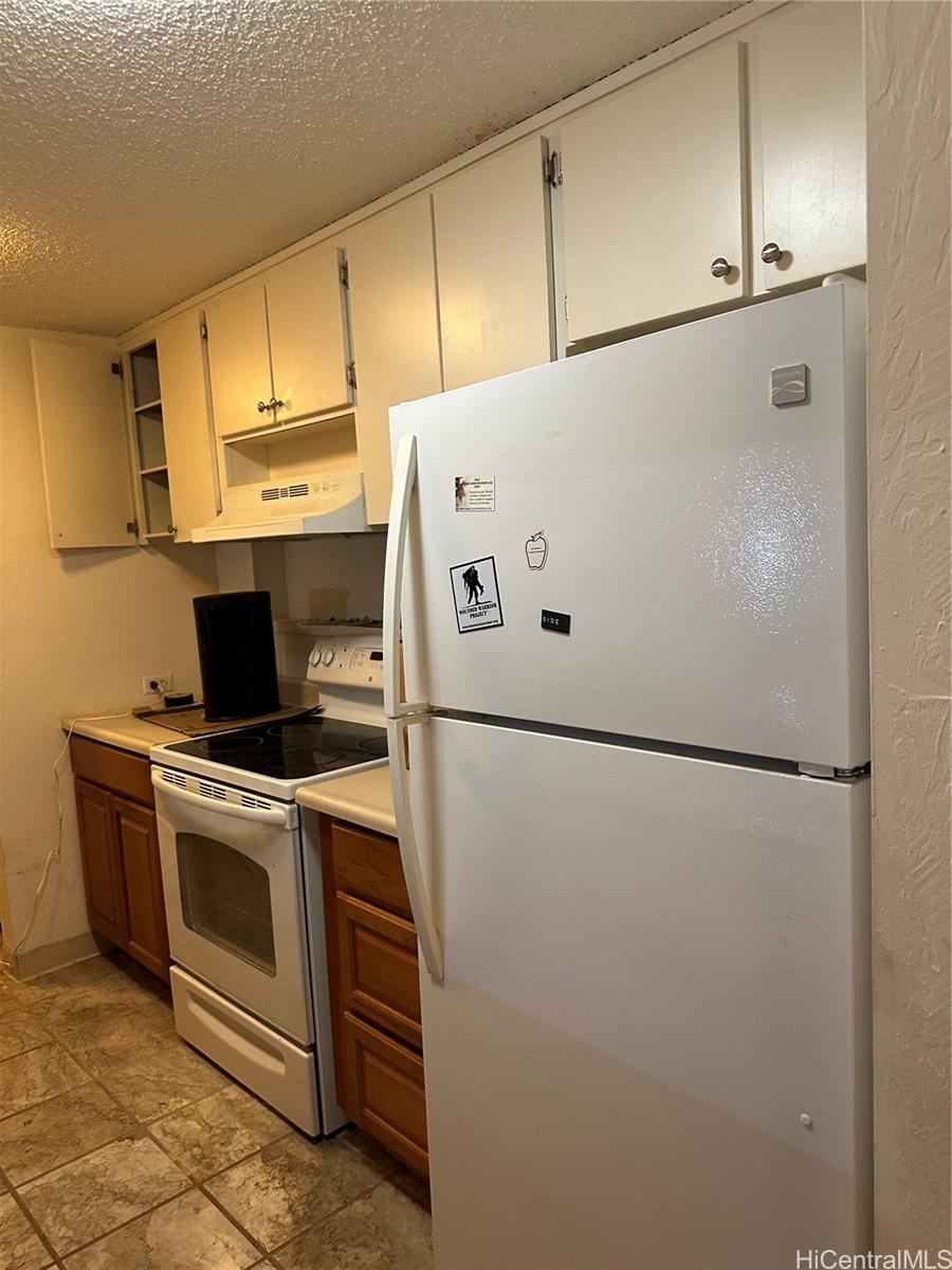 a white refrigerator freezer sitting in a kitchen