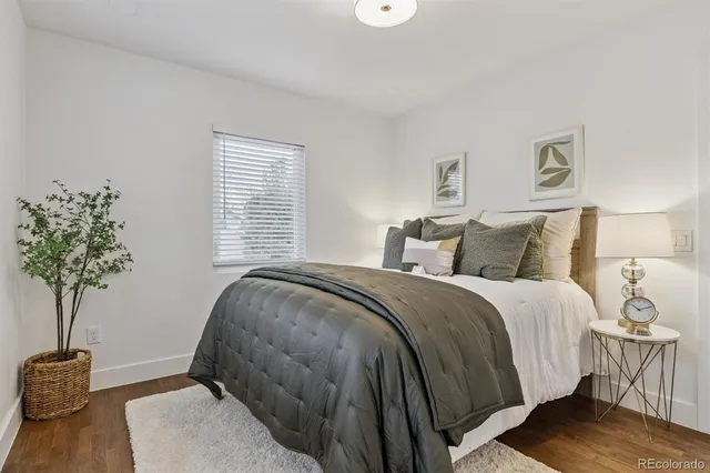 a bedroom with a bed and a potted plant