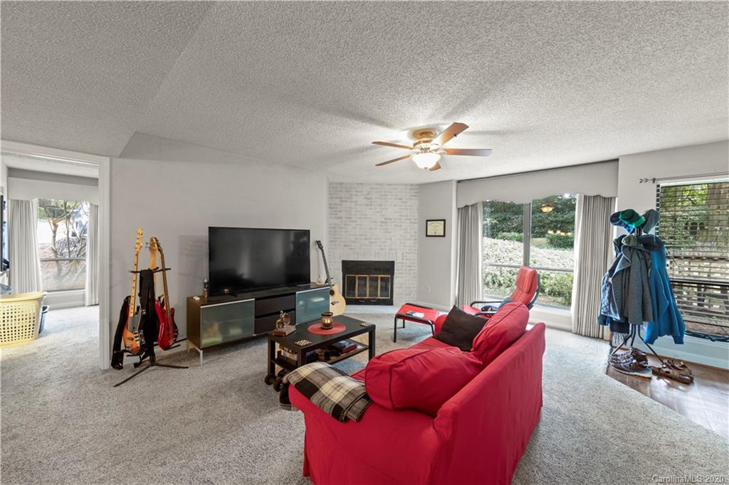 1606 Sharon Road West, Unit 33 Charlotte, NC 28210 - Photo 2 of 19 a living room with furniture and a flat screen tv