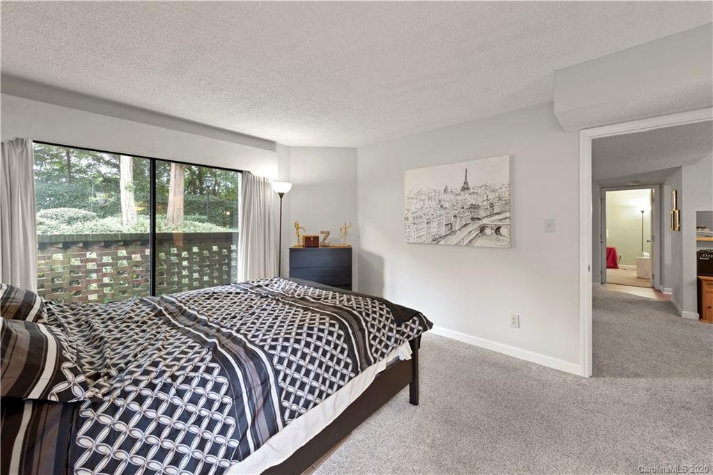 1606 Sharon Road West, Unit 33 Charlotte, NC 28210 - Photo 13 of 19 a bedroom with a large bed and a window