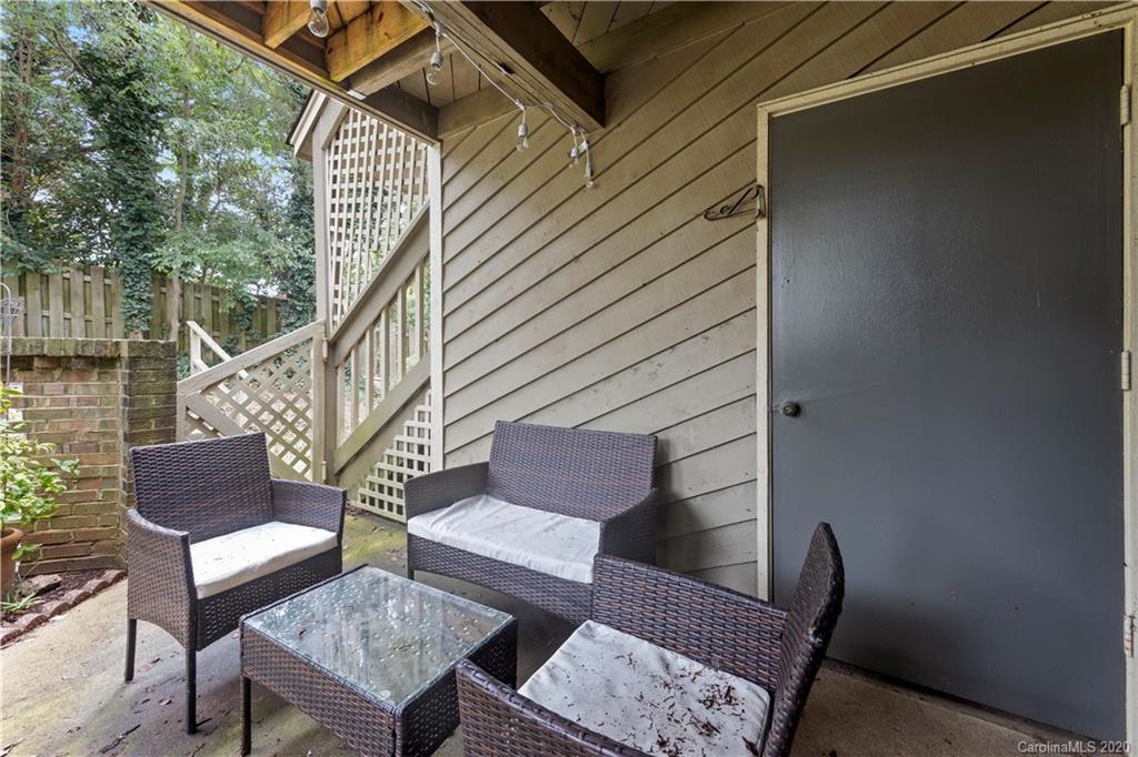 1606 Sharon Road West, Unit 33 Charlotte, NC 28210 - Photo 17 of 19 a view of balcony with wooden floor and outdoor seating