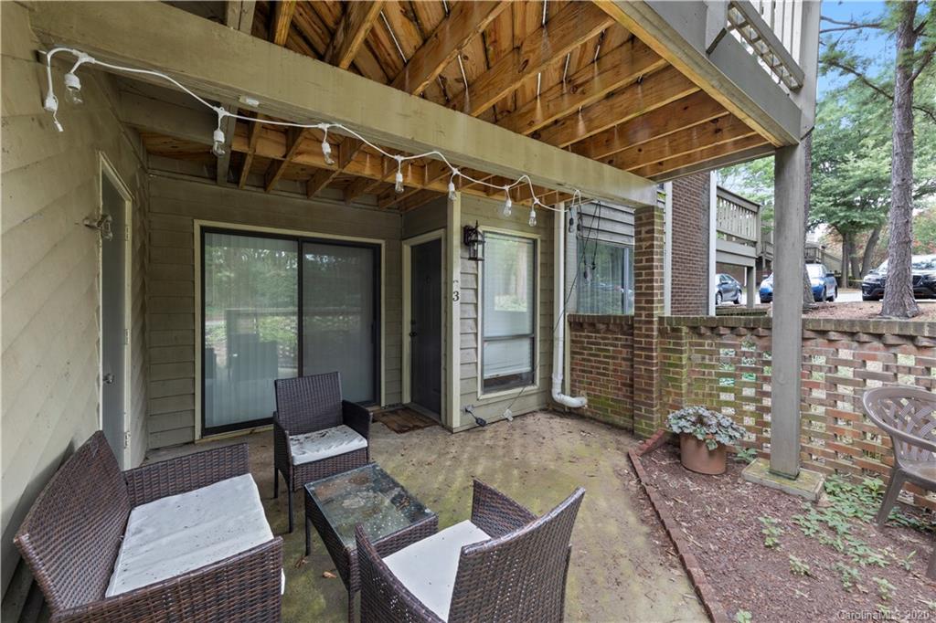 1606 Sharon Road West, Unit 33 Charlotte, NC 28210 - Photo 18 of 19 a view of a patio with a table and chairs