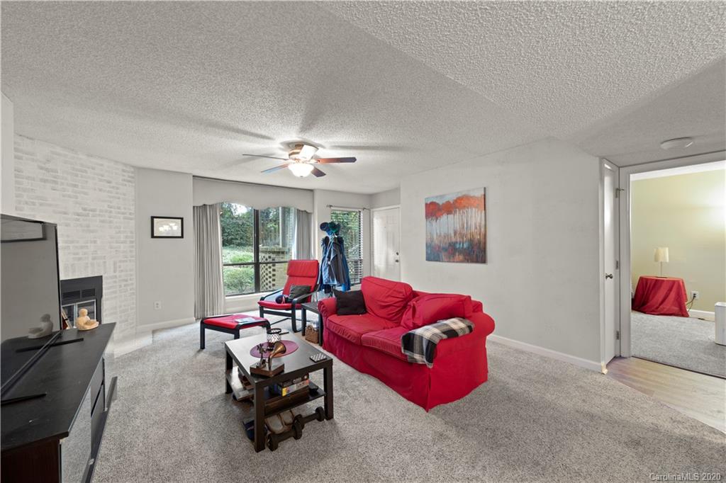 1606 Sharon Road West, Unit 33 Charlotte, NC 28210 - Photo 4 of 19 a living room with furniture and a flat screen tv