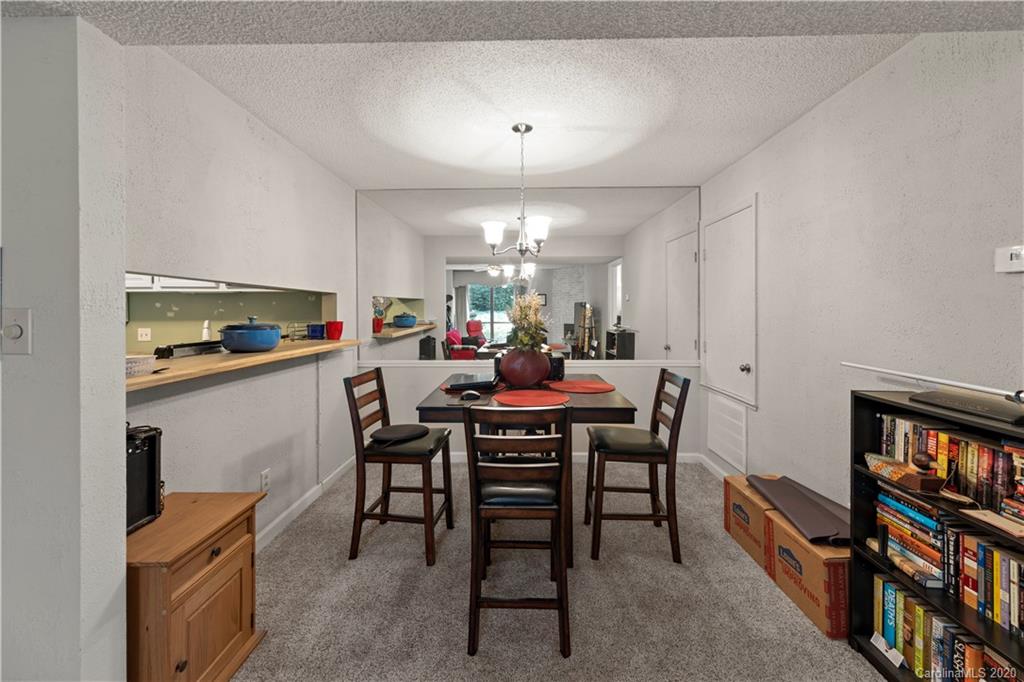 1606 Sharon Road West, Unit 33 Charlotte, NC 28210 - Photo 5 of 19 a view of a a dining room with furniture window and wooden floor