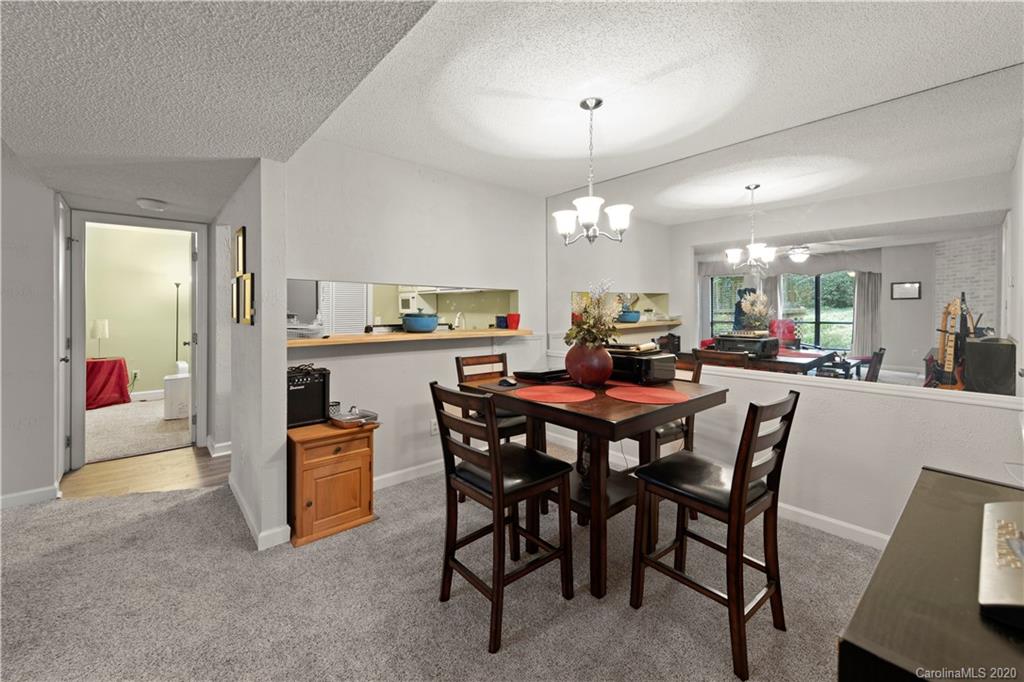 1606 Sharon Road West, Unit 33 Charlotte, NC 28210 - Photo 6 of 19 a view of a dining room with furniture and chandelier