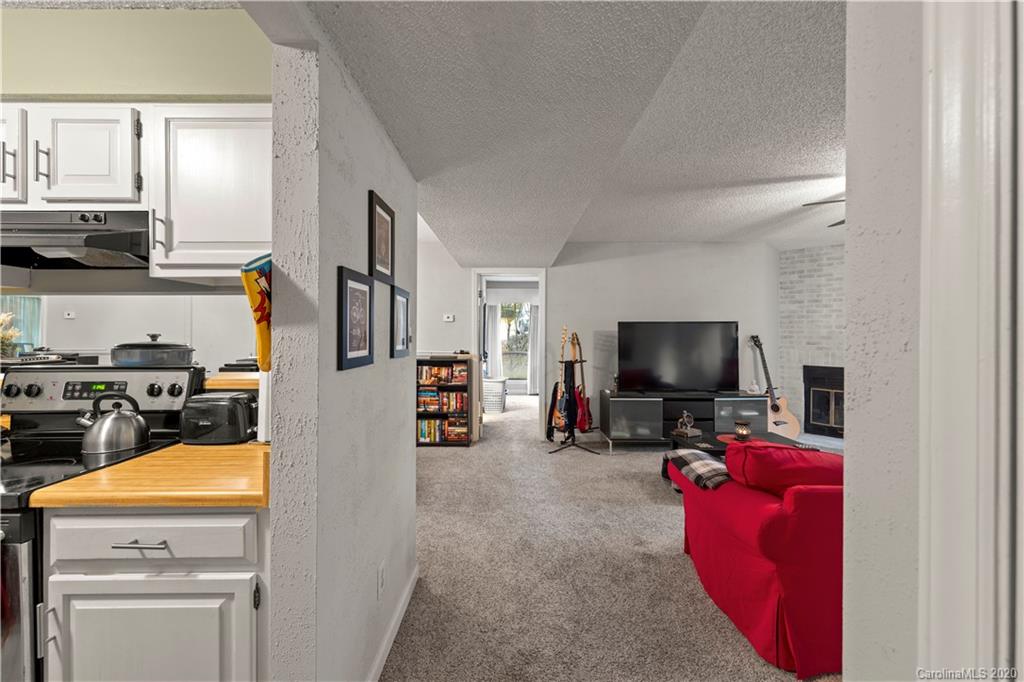 1606 Sharon Road West, Unit 33 Charlotte, NC 28210 - Photo 7 of 19 a view of a livingroom with workspace and a couch