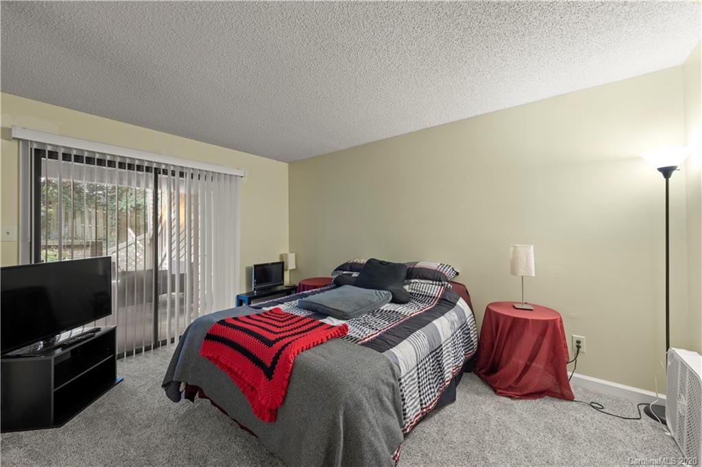 1606 Sharon Road West, Unit 33 Charlotte, NC 28210 - Photo 10 of 19 a bedroom with a bed and flat screen tv