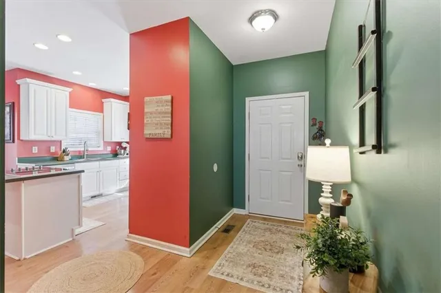 a kitchen with kitchen island granite countertop a sink and cabinets