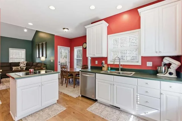 a kitchen with stainless steel appliances a refrigerator sink and cabinets