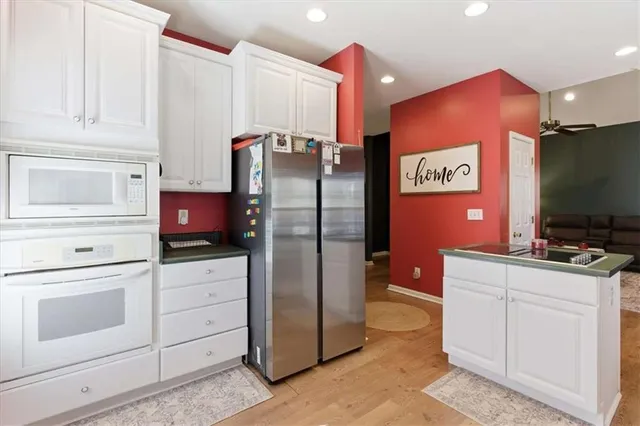 a dining room with a table chairs and a kitchen view