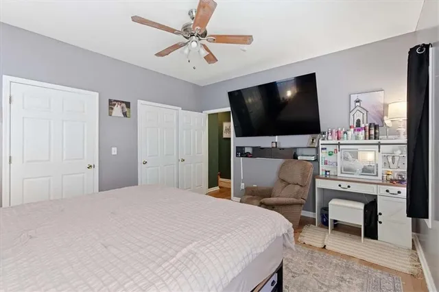 a bedroom with a bed lamps and a fireplace