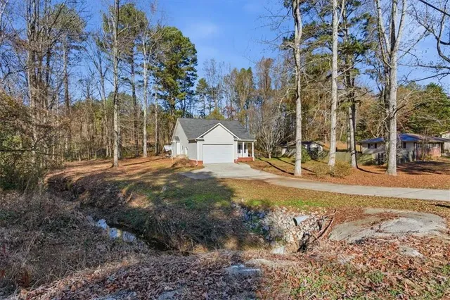 a backyard of apartments with large trees