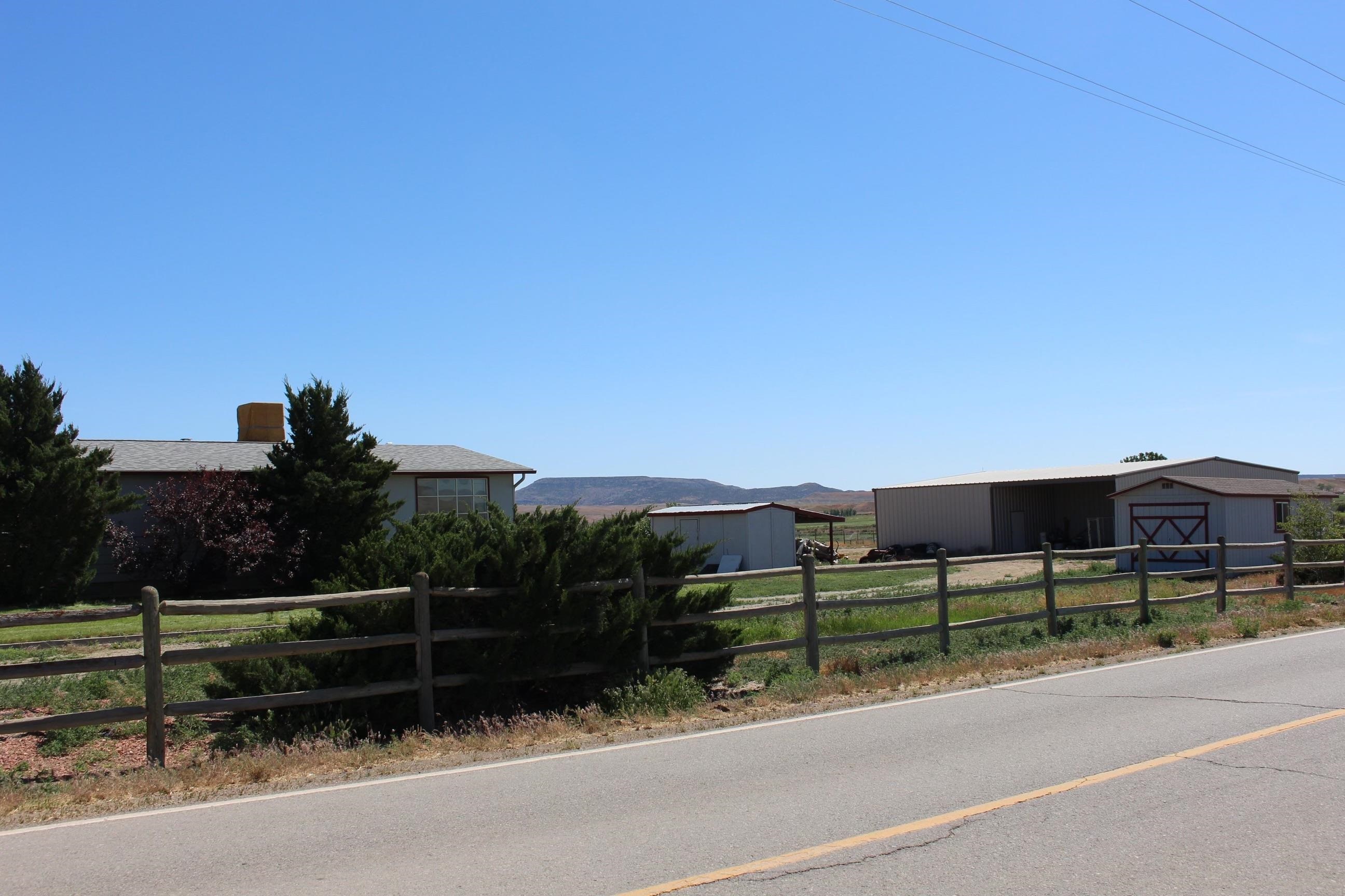 899 R Road Mack, CO 81525 - Photo 16 of 20 a view of a street with a bench in front of it