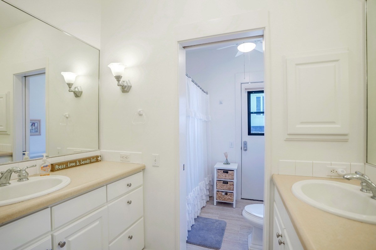 8264 Elepaio Road, Unit B Kekaha, HI 96752 - Photo 23 of 27 a bathroom with a double vanity sink mirror double and bathtub