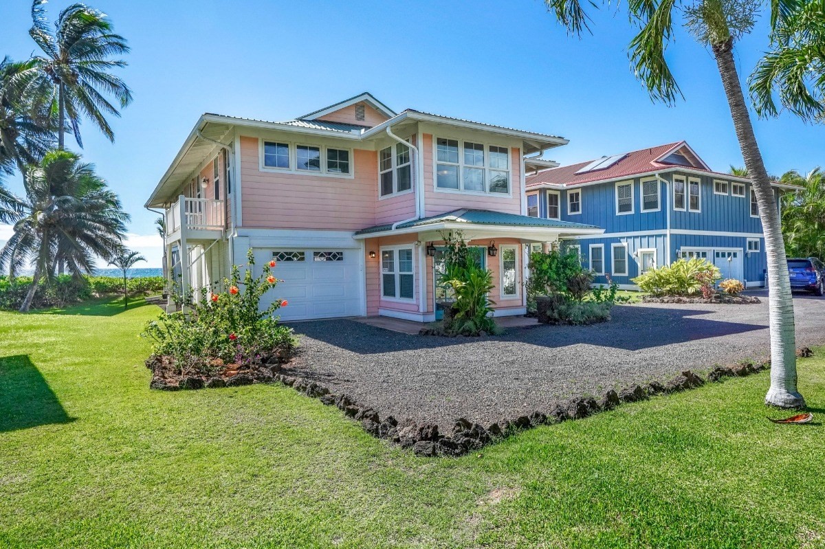 8264 Elepaio Road, Unit B Kekaha, HI 96752 - Photo 5 of 27 a front view of a house with a garden