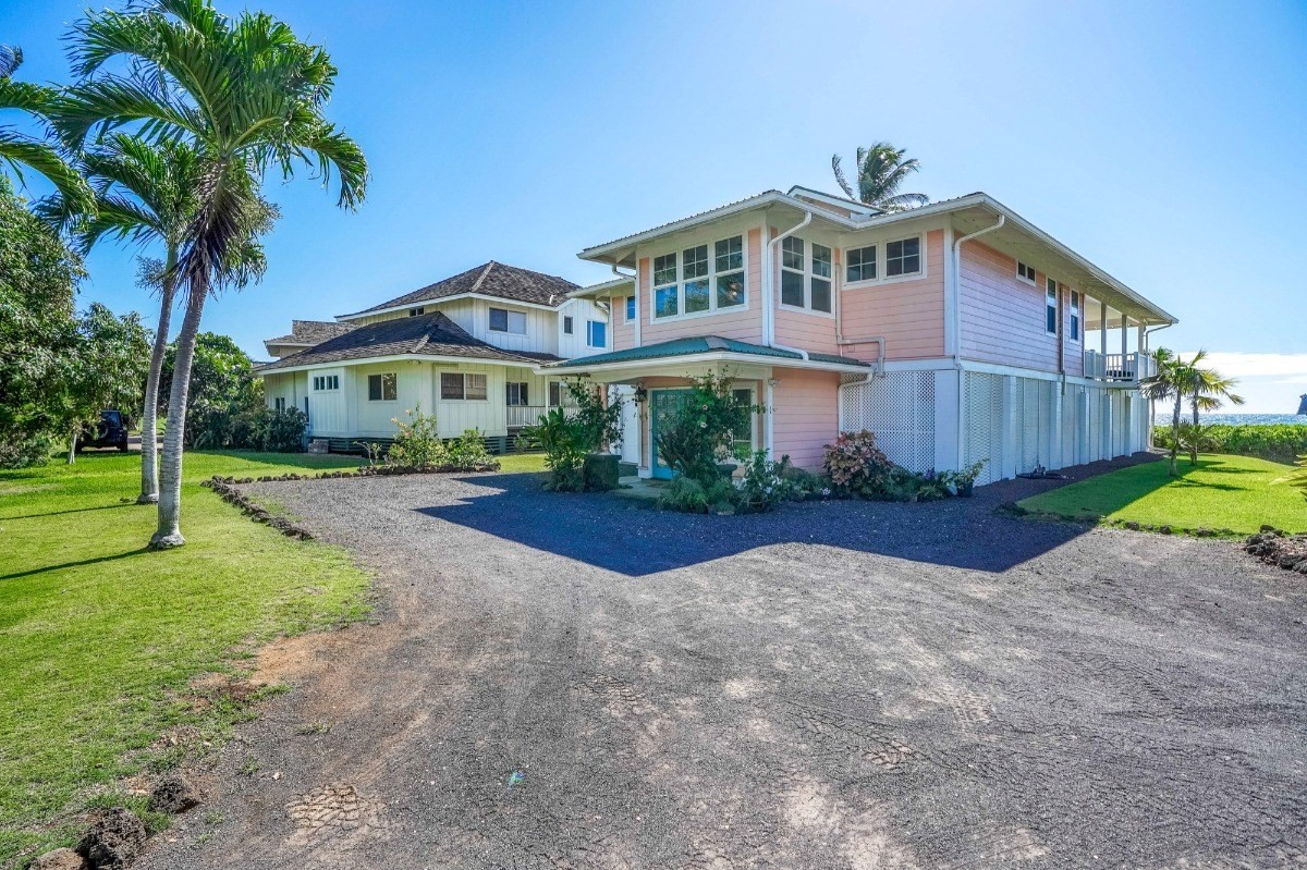 8264 Elepaio Road, Unit B Kekaha, HI 96752 - Photo 8 of 27 a view of a house with a yard and palm tree