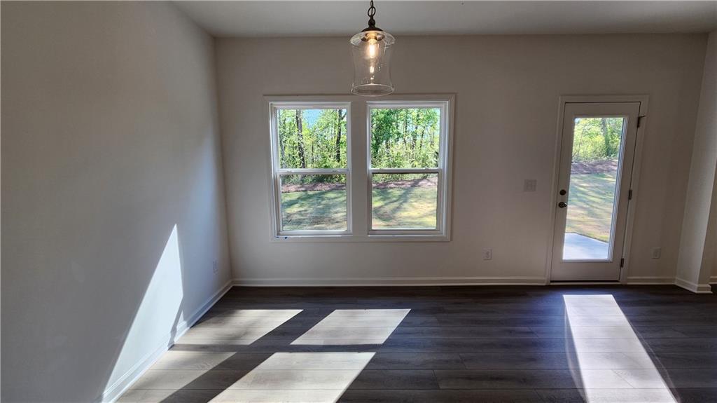 204 Silverleaf Trail Bethlehem, GA 30620 - Photo 12 of 41 an empty room with wooden floor and windows