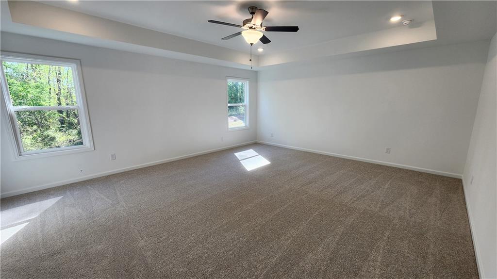 204 Silverleaf Trail Bethlehem, GA 30620 - Photo 16 of 41 en empty room with windows and ceiling fan