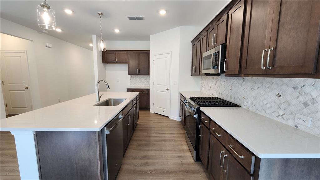 204 Silverleaf Trail Bethlehem, GA 30620 - Photo 10 of 41 a kitchen with a sink stove and cabinets