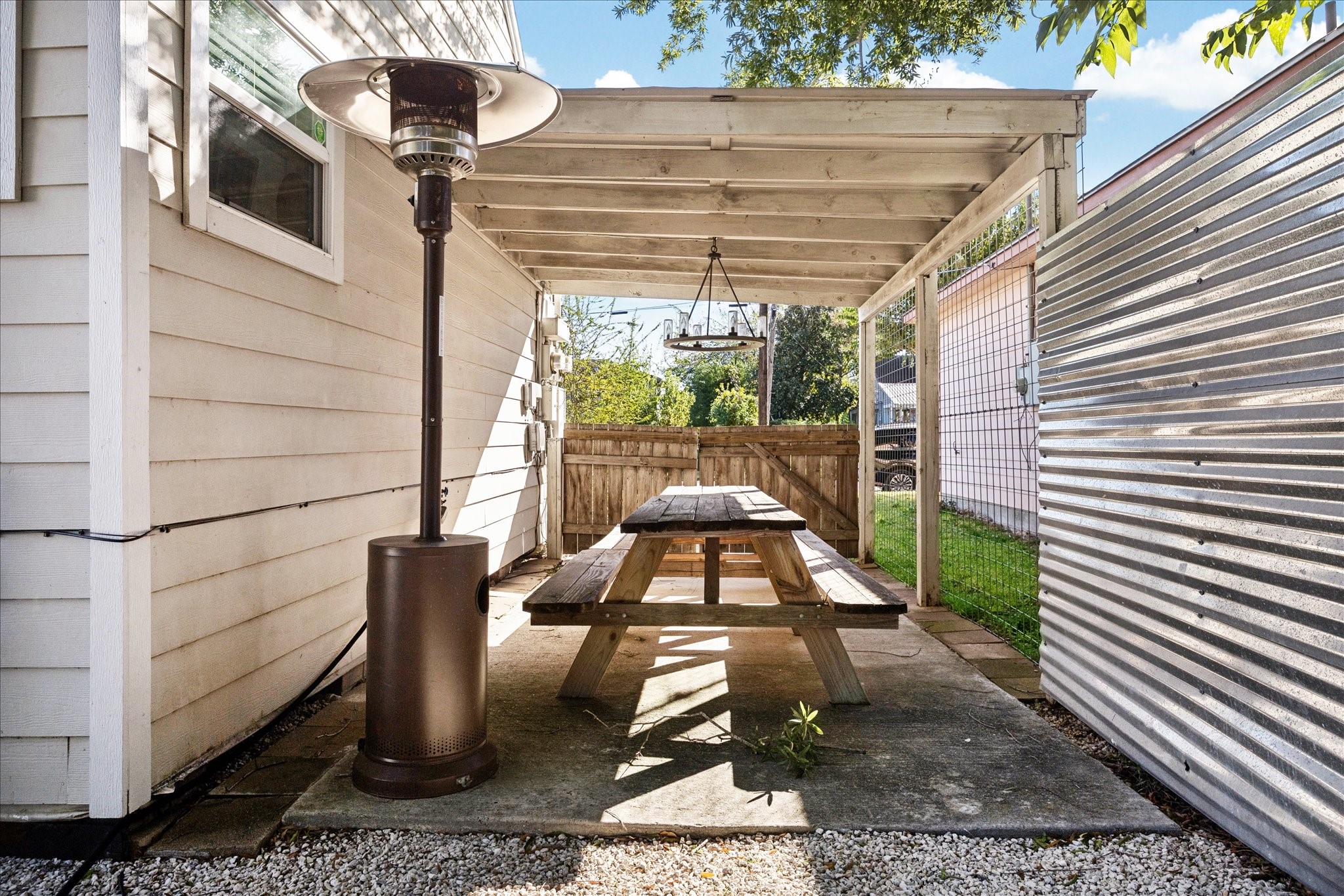 5651 Truett Street Houston, TX 77023 - Photo 18 of 19 a view of a patio with table and chairs and wooden floor