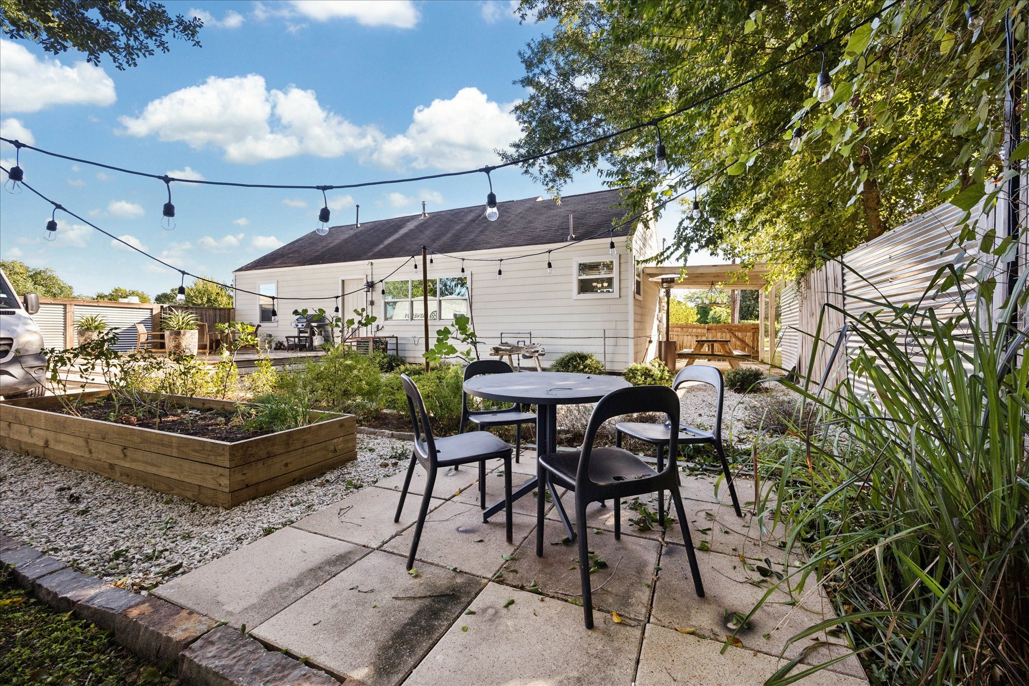 5651 Truett Street Houston, TX 77023 - Photo 19 of 19 a view of a patio with table and chairs under an umbrella