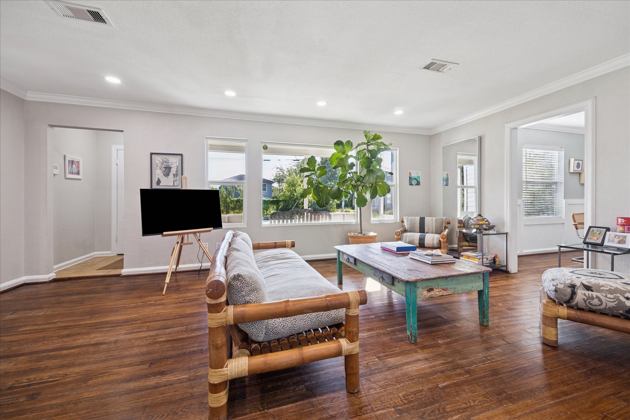 5651 Truett Street Houston, TX 77023 - Photo 4 of 19 a living room with furniture a flat screen tv and a wooden floor