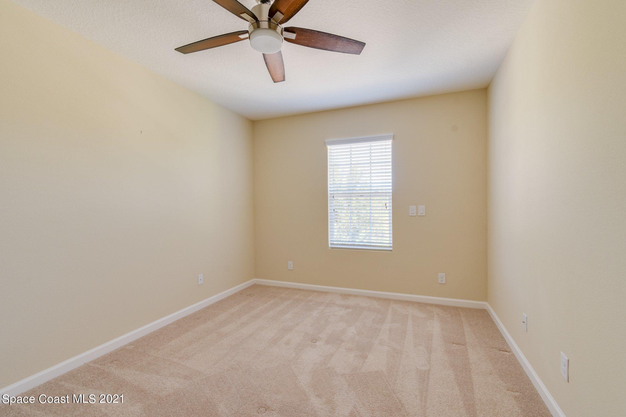 2780 Reston Street, Unit 102 Melbourne, FL 32935 - Photo 15 of 36 an empty room with a window and a fan