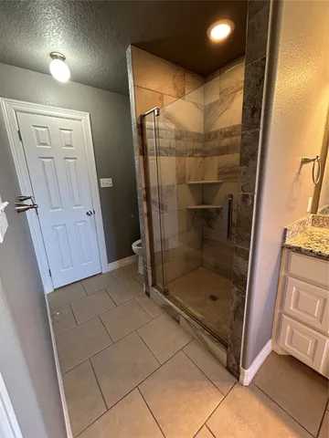 a bathroom with a glass shower door