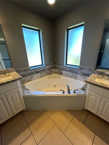 a bathroom with a bathtub and a window