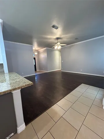 a view of a livingroom with an empty space and a chandelier
