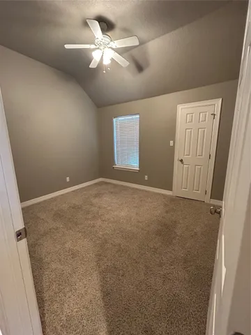 en empty room with windows and fan