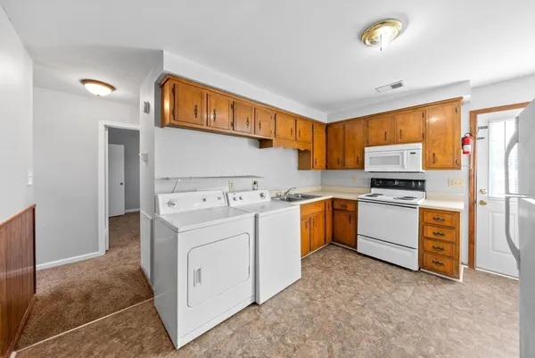 a kitchen with a sink stove and refrigerator