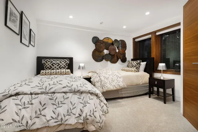 a bedroom with a bed window and lamp