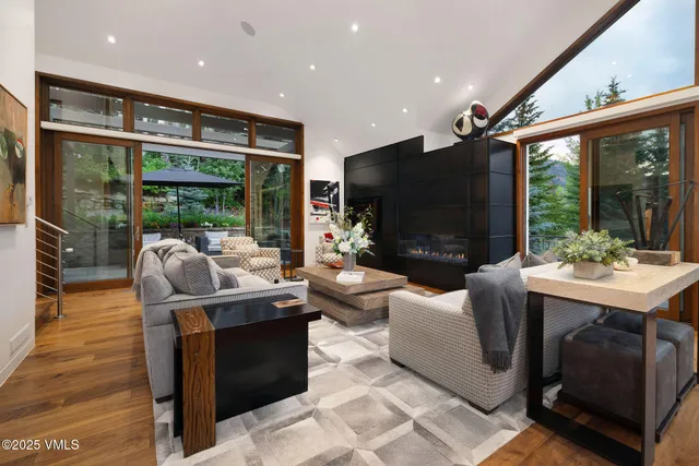 a living room with patio fireplace furniture and a flat screen tv