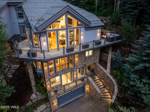 an aerial view of green landscape with trees houses and mountain view