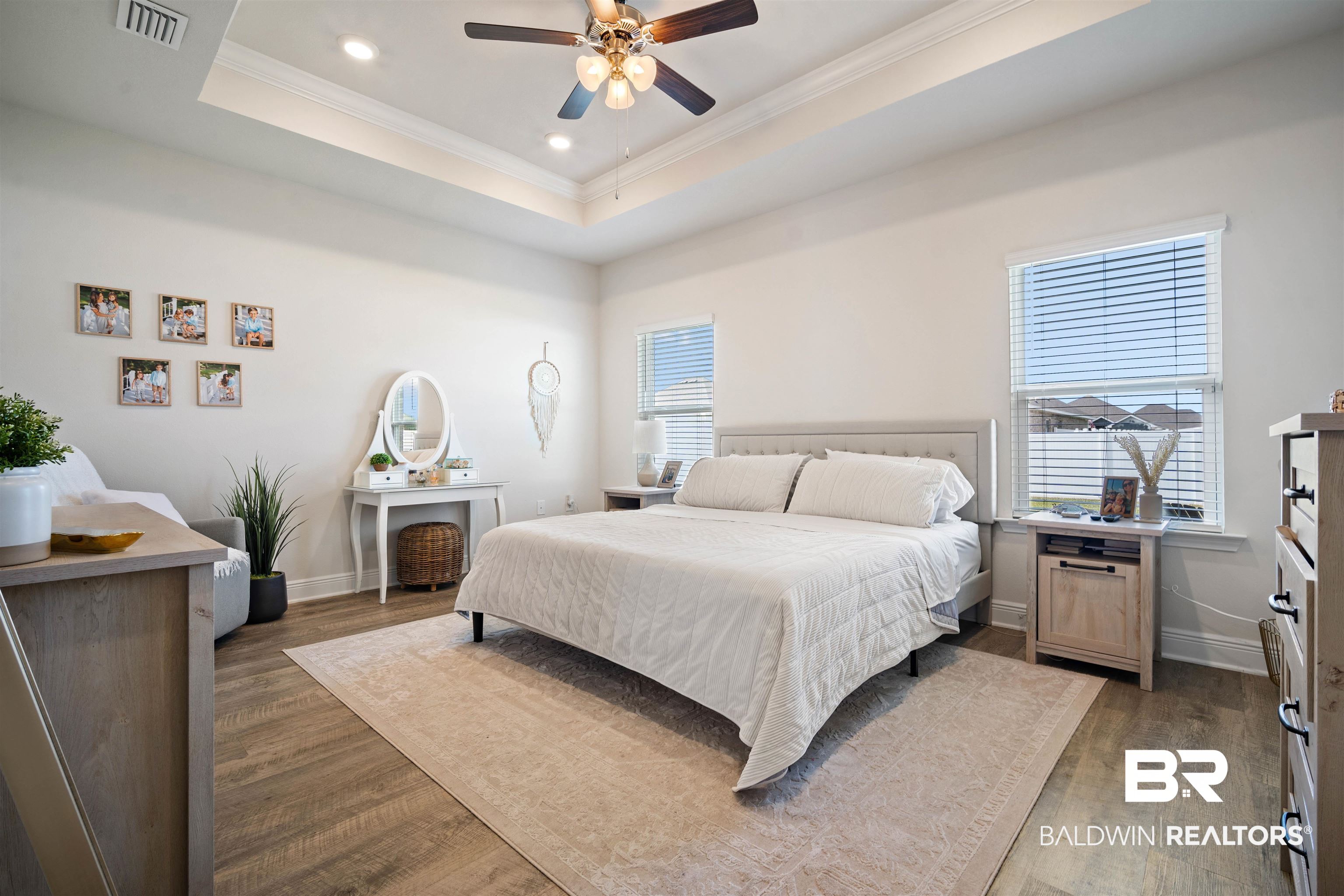 11021 Native Dancer Way Daphne, AL 36526 - Photo 11 of 35 Bedroom featuring wood finished floors, visible vents, crown molding, and multiple windows