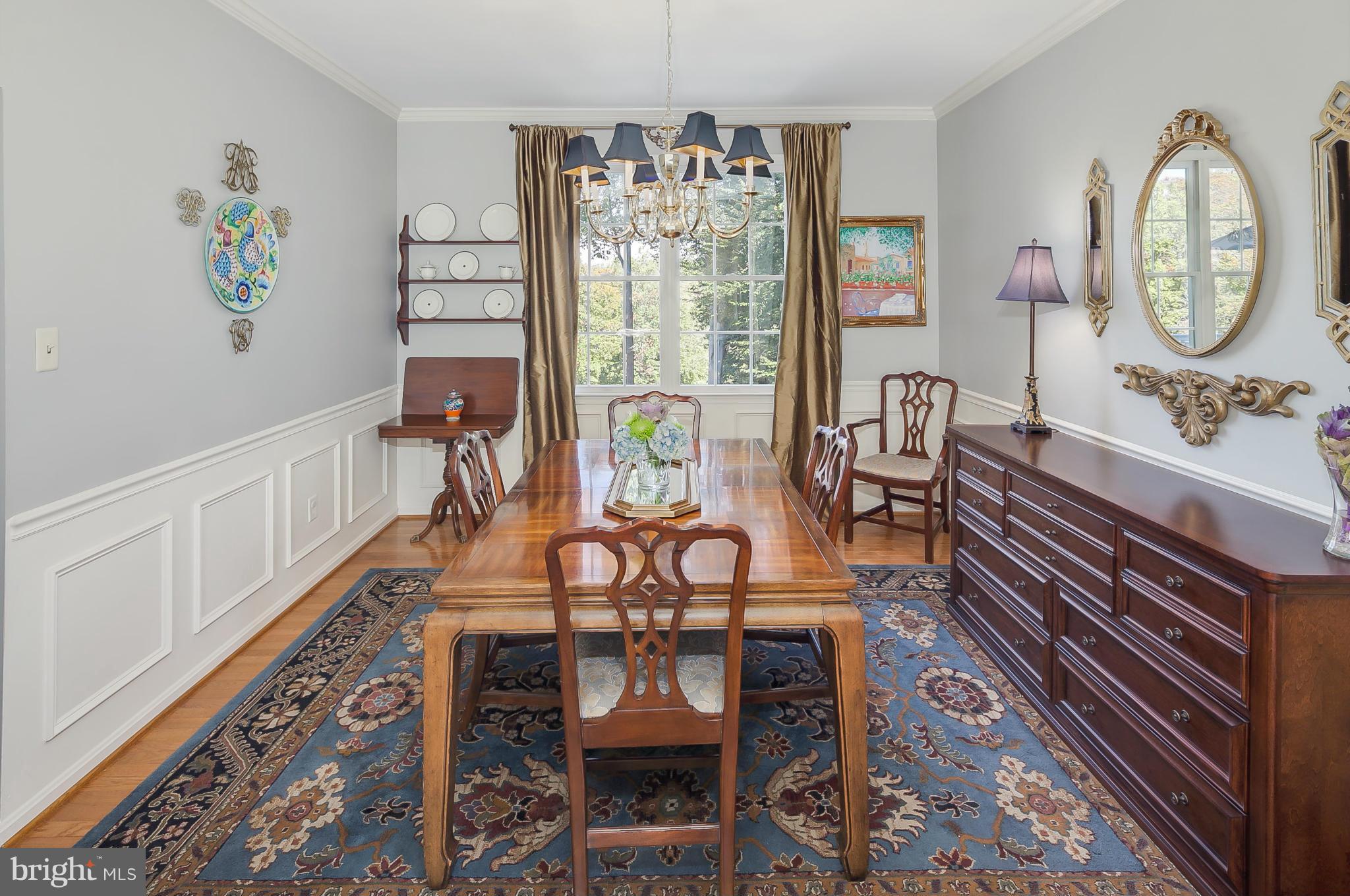 5949 Sandy Ridge Elkridge, MD 21075 - Photo 5 of 30 a view of a dining room with furniture a chandelier and wooden floor