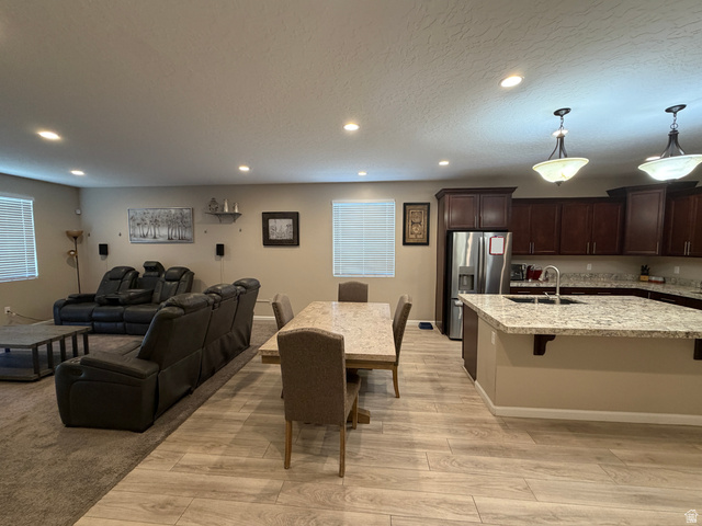 118 Tram Rock Rd. Lake Point, UT 84074 - Photo 11 of 34 Open-concept living area featuring wood-finish flooring, recessed lighting, and ample natural light from multiple windows