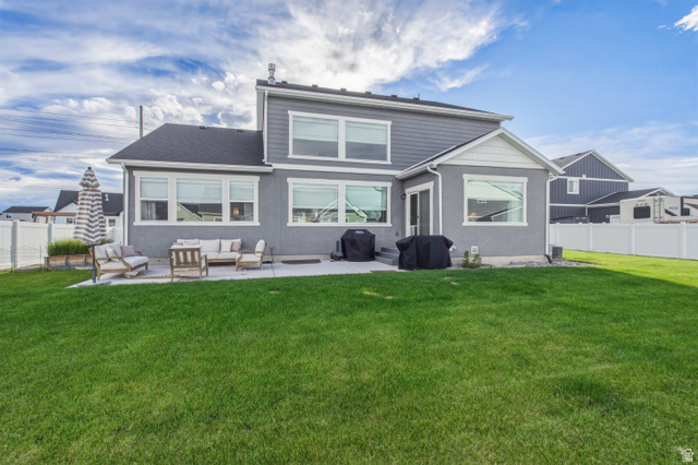 870 North Ada Loop Lehi, UT 84048 - Photo 47 of 51 Expansive green lawn with a gray stucco and siding exterior