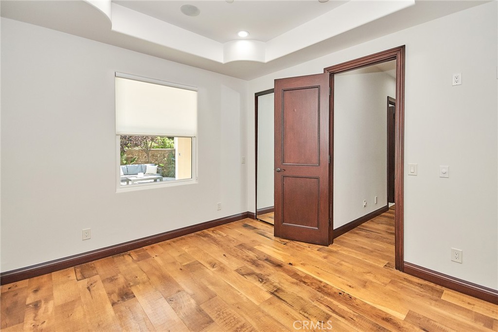 1051 Arroyo Drive Fullerton, CA 92833 - Photo 15 of 73 an empty room with wooden floor and a window