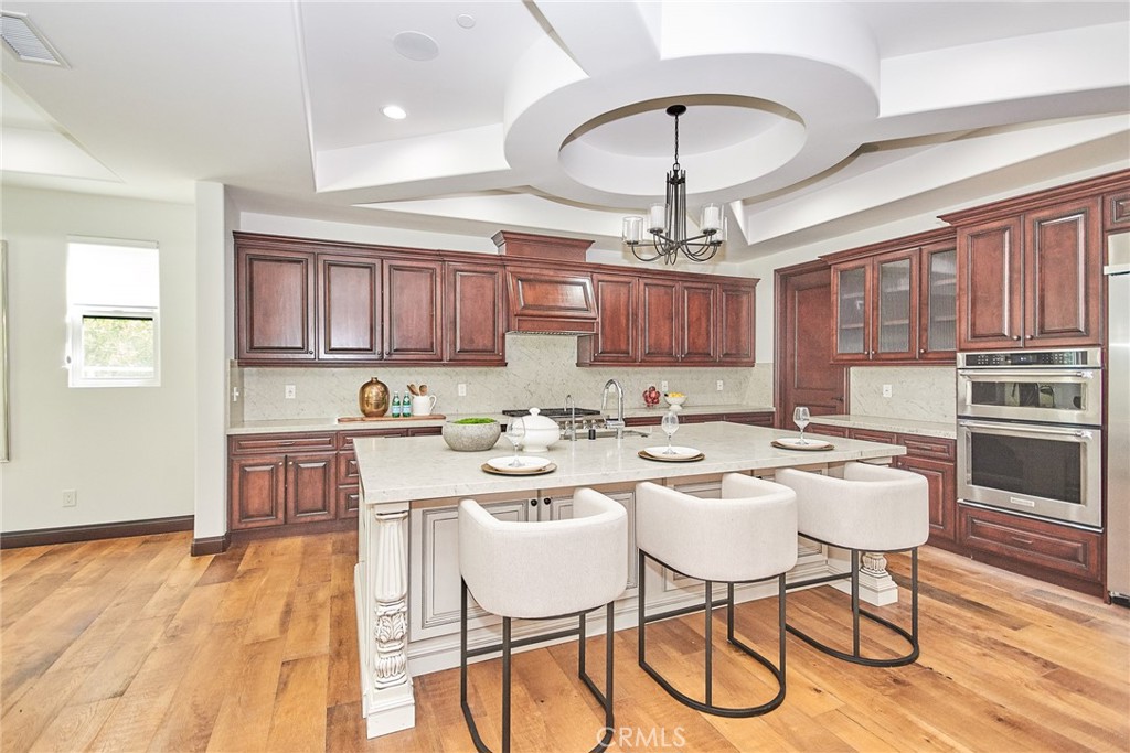 1051 Arroyo Drive Fullerton, CA 92833 - Photo 31 of 73 a kitchen with a table chairs stove and cabinets
