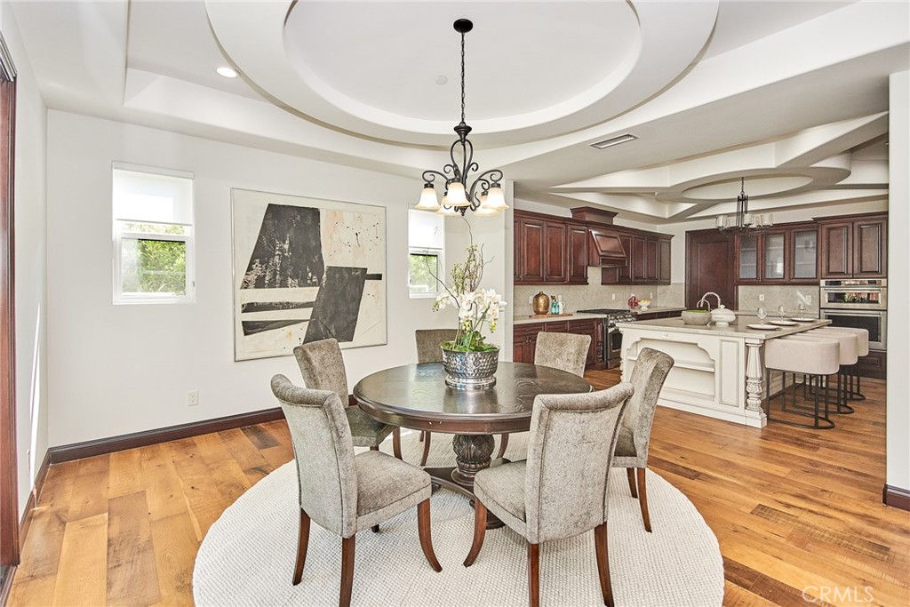 1051 Arroyo Drive Fullerton, CA 92833 - Photo 38 of 73 a dining room with furniture a chandelier and wooden floor
