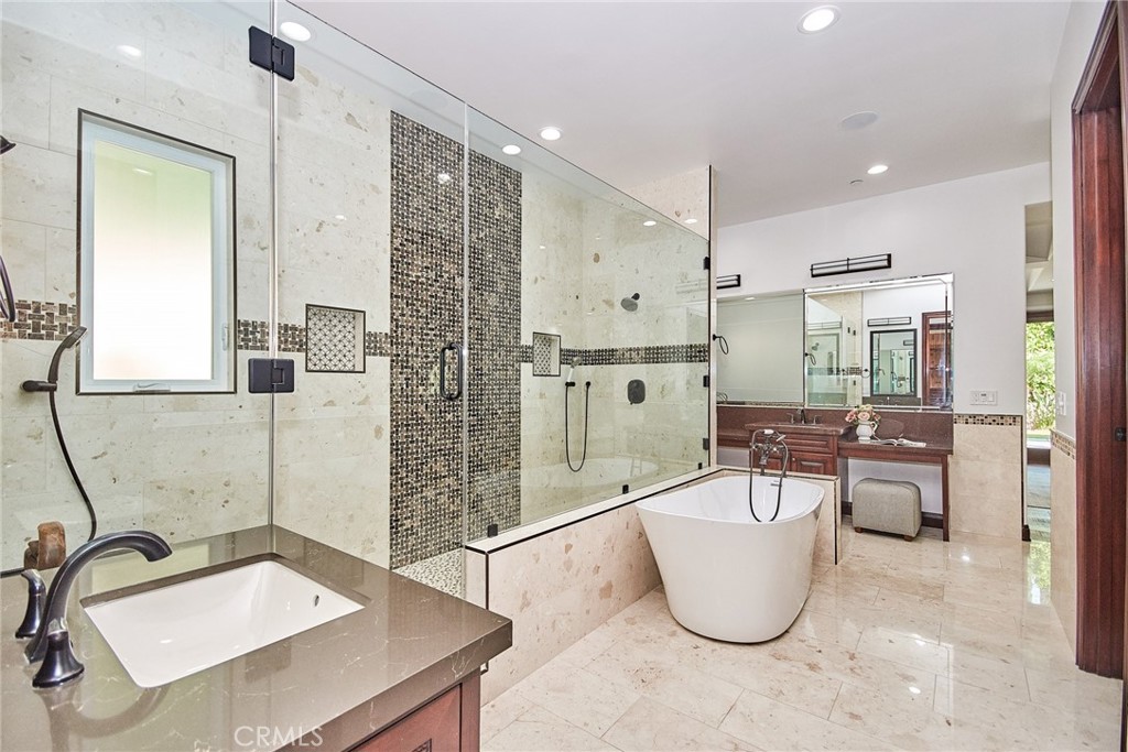 1051 Arroyo Drive Fullerton, CA 92833 - Photo 46 of 73 a bathroom with a tub a sink a mirror and a shower