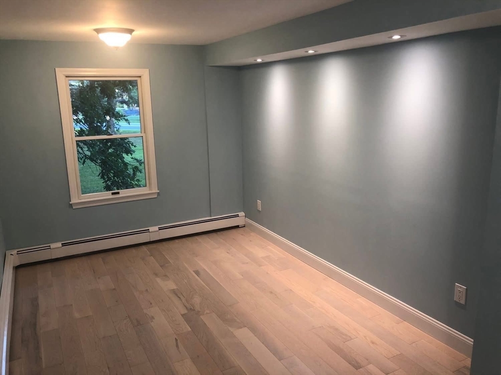 63 River Street, Unit 1 Middleton, MA 01949 - Photo 11 of 19 an empty room with a window