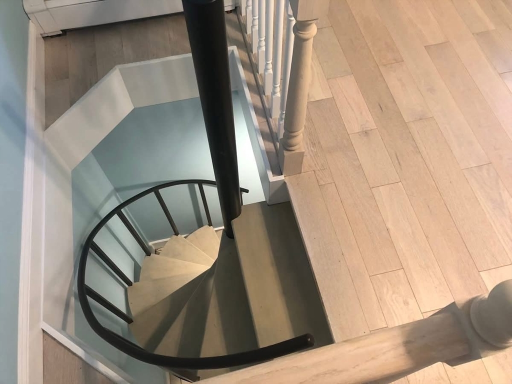 63 River Street, Unit 1 Middleton, MA 01949 - Photo 13 of 19 a view of staircase with wooden floor and chair