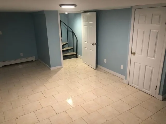 a view of an empty room and stairs