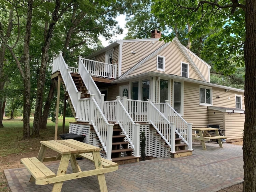 63 River Street, Unit 1 Middleton, MA 01949 - Photo 2 of 19 a front view of a house with a yard