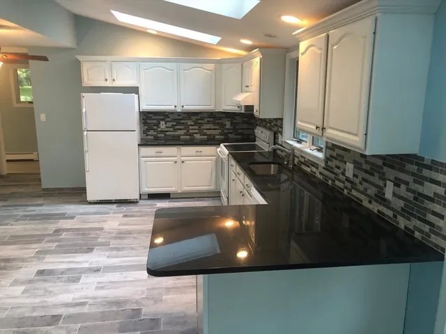 a kitchen with a sink and a refrigerator