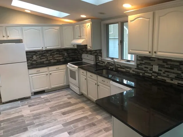 a kitchen with a sink and cabinets